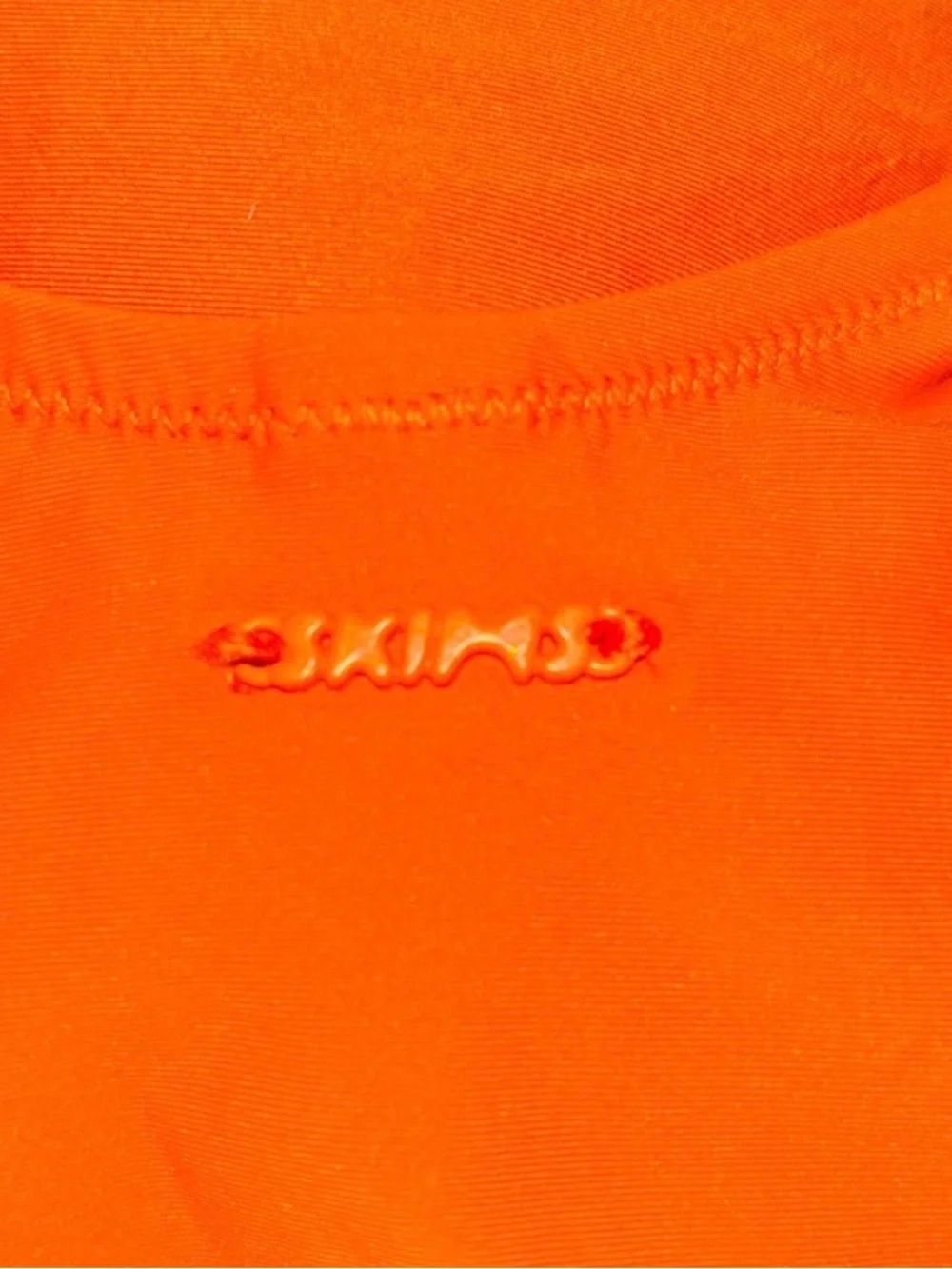 Skims signature swim one piece in Tangerine